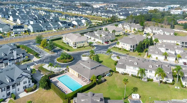 an aerial view of residential houses with outdoor space