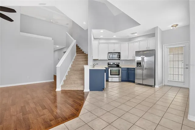 a open kitchen with stainless steel appliances granite countertop a refrigerator and a sink