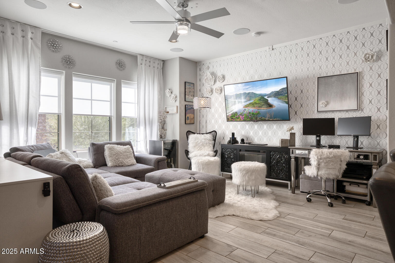 3935 East Rough Rider Road, Unit 1267 Phoenix, AZ 85050 - Photo 2 of 37 a living room with furniture and a flat screen tv