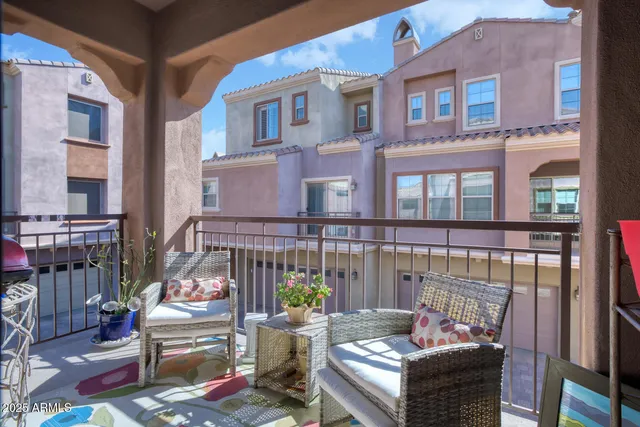 a view of a patio with couches table and chairs and potted plants
