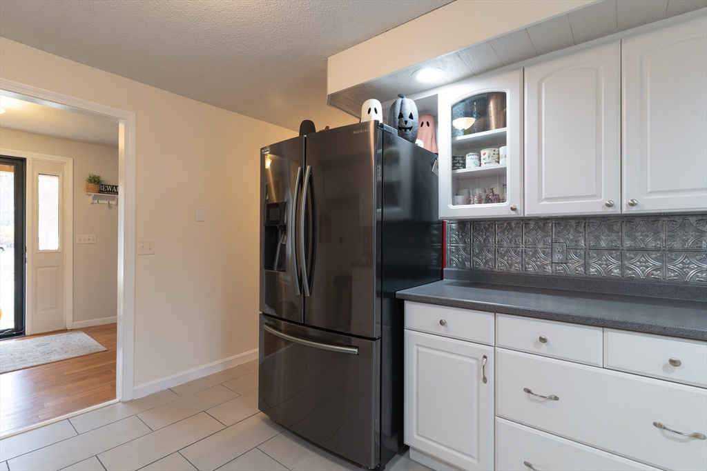 15 Cherokee Road Holland, MA 01521 - Photo 12 of 42 a metallic refrigerator freezer sitting in a kitchen