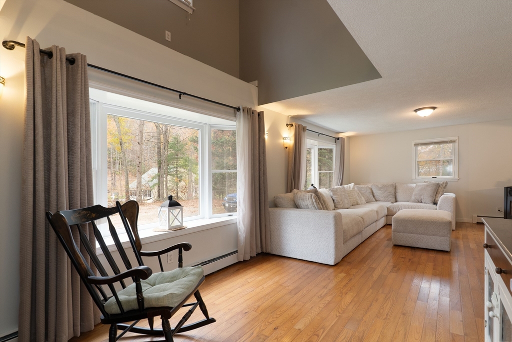 15 Cherokee Road Holland, MA 01521 - Photo 19 of 42 a living room with fireplace furniture and a large window