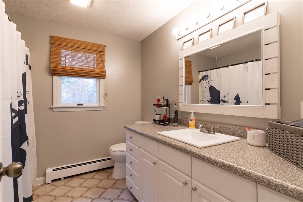 15 Cherokee Road Holland, MA 01521 - Photo 30 of 42 a bathroom with a sink a toilet and mirror