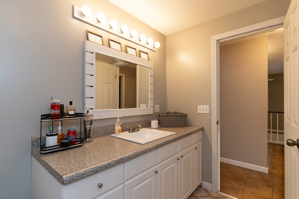 15 Cherokee Road Holland, MA 01521 - Photo 32 of 42 a bathroom with a granite countertop sink and a mirror