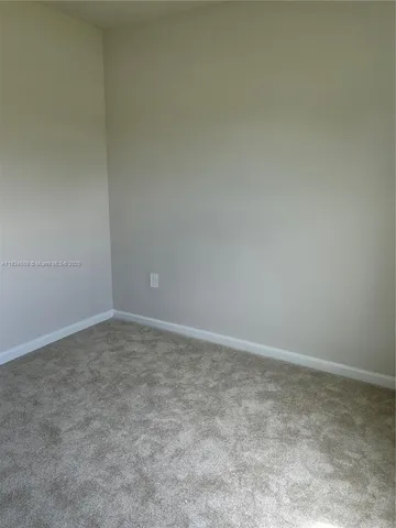 a bathroom with a granite countertop bathtub shower sink vanity and toilet