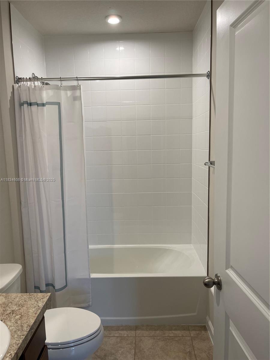 217 Raspberry Road Fort Pierce, FL 34981 - Photo 31 of 39 a bathroom with a granite countertop bathtub shower sink vanity and toilet