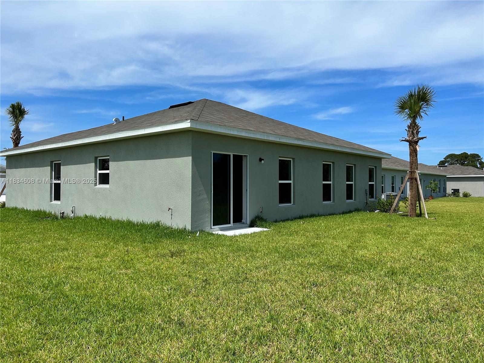 217 Raspberry Road Fort Pierce, FL 34981 - Photo 33 of 39 a backyard of a house with lots of green space