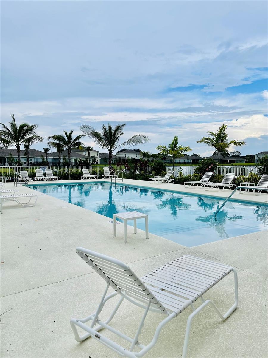 217 Raspberry Road Fort Pierce, FL 34981 - Photo 36 of 39 a view of swimming pool with outdoor seating and plants