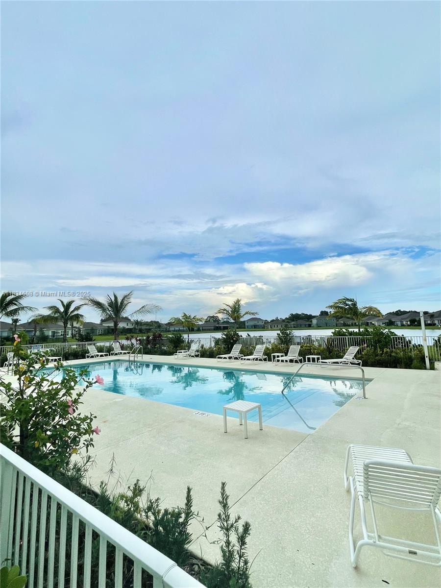 217 Raspberry Road Fort Pierce, FL 34981 - Photo 37 of 39 a view of a lake with houses in the back