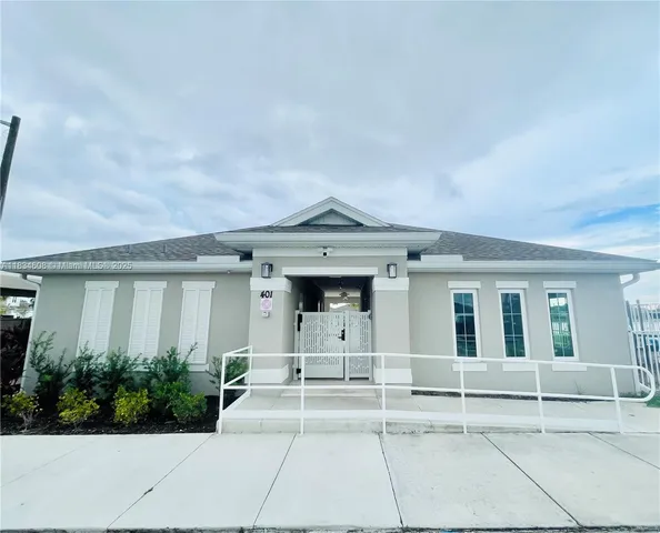 a living room with furniture a rug and white walls