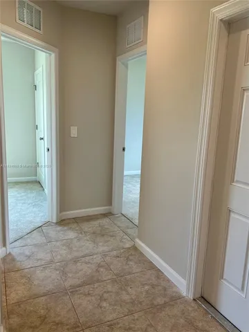 an empty room with closet and a bathroom