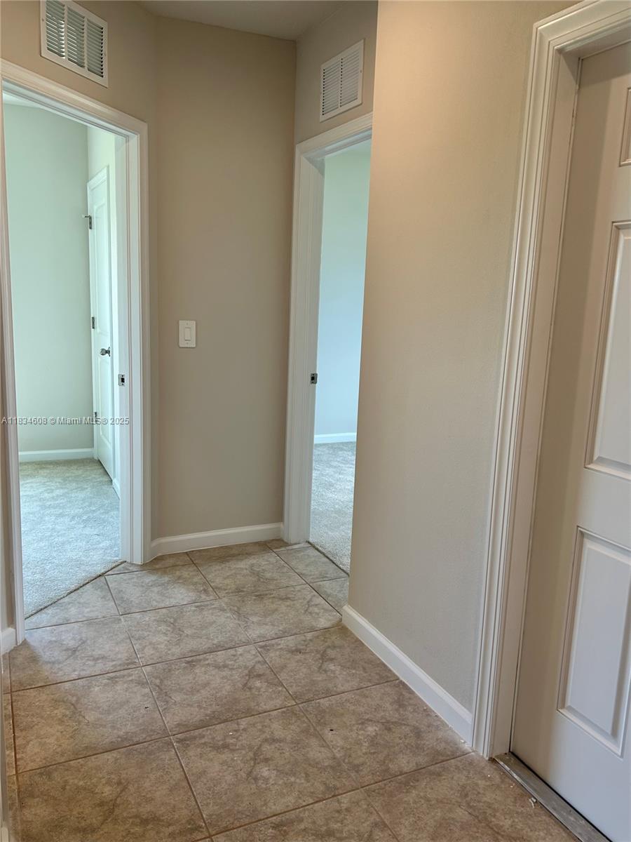 217 Raspberry Road Fort Pierce, FL 34981 - Photo 5 of 39 an empty room with closet and a bathroom