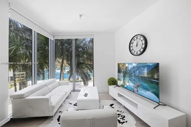 a living room with couch and a large window