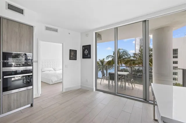 a kitchen with granite countertop a refrigerator and a stove top oven