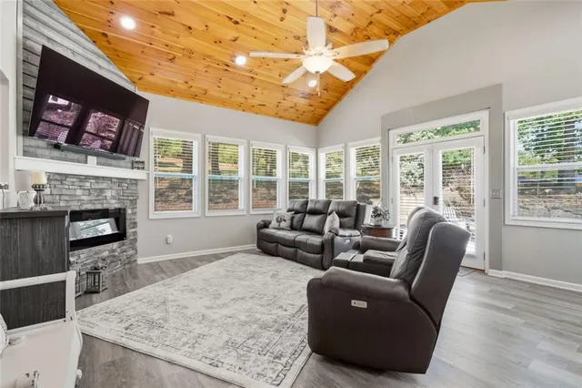 a living room with furniture a flat screen tv and a fireplace