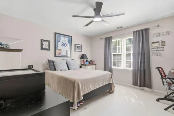 a bedroom with a bed and a chandelier