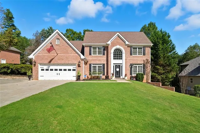 a front view of a house with a yard