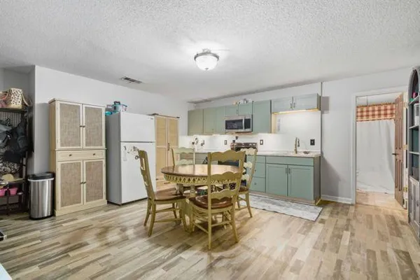 a view of a dining room with furniture and wooden floor