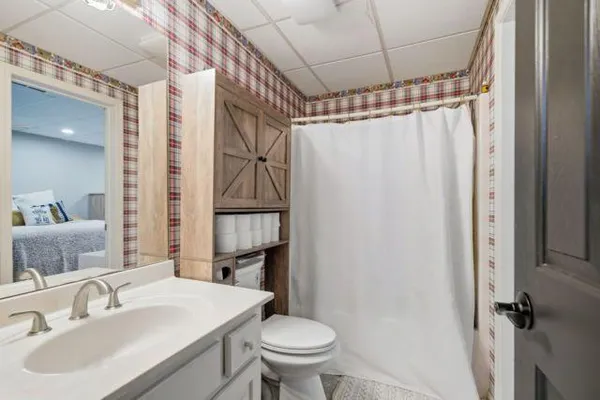 a bathroom with a sink toilet and shower