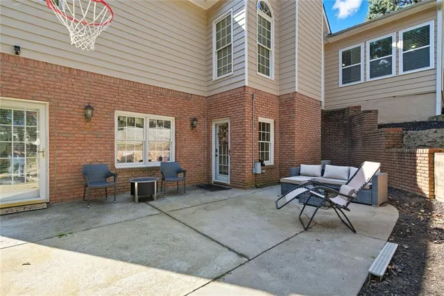a building outdoor space with patio furniture and potted plants
