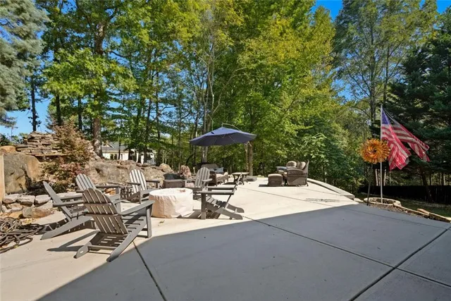a view of a patio with table and chairs under an umbrella