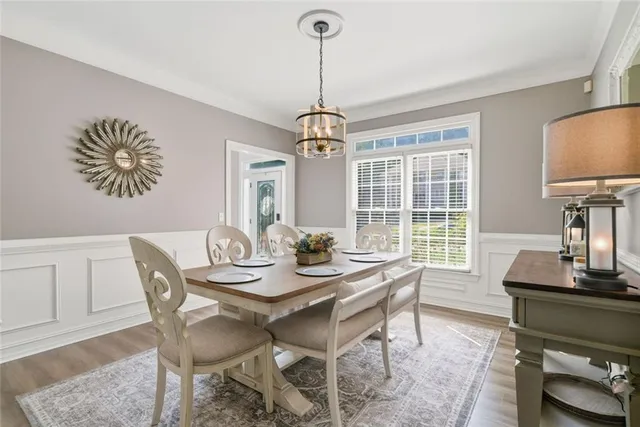 a dining room with furniture a chandelier and window