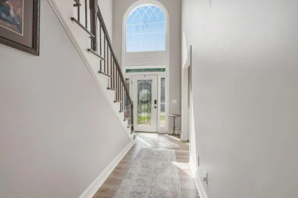 a view of staircase with railing and white walls