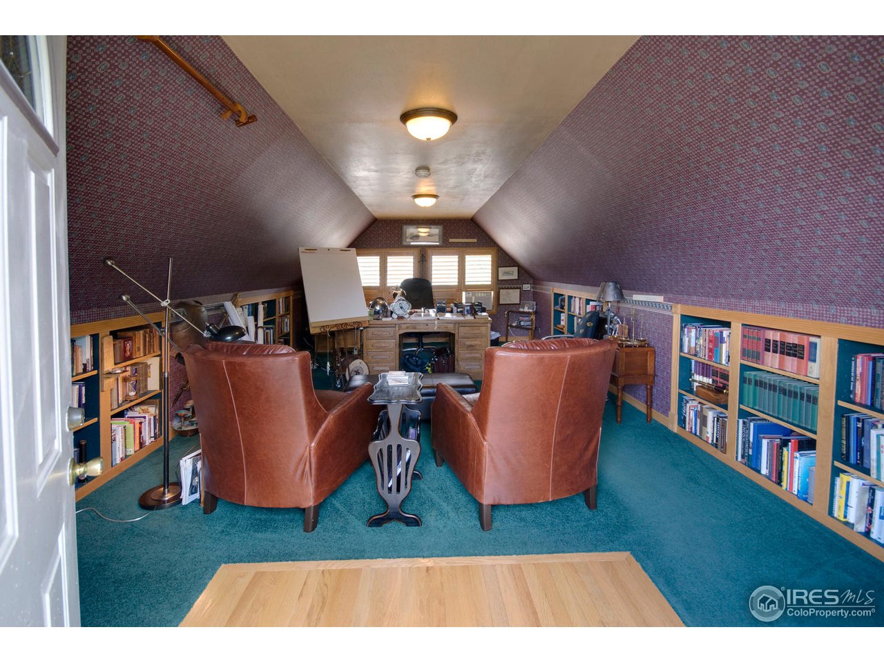 406 East Baseline Road Lafayette, CO 80026 - Photo 24 of 24 a living room with furniture and a book shelf
