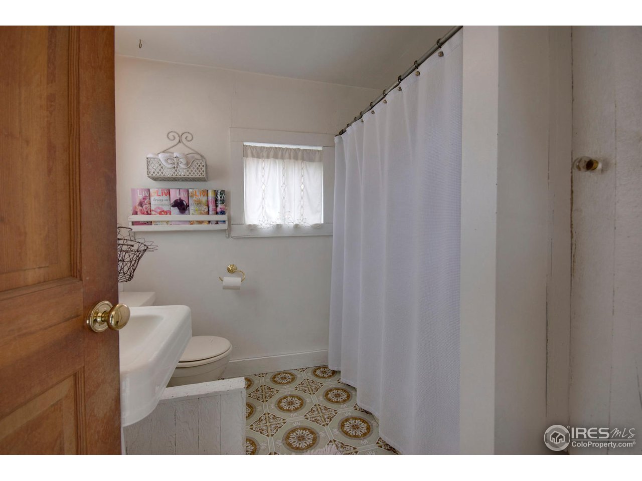 406 East Baseline Road Lafayette, CO 80026 - Photo 7 of 24 a bathroom with a sink and a toilet
