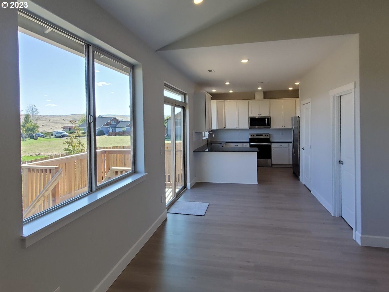 1435 Fish Tail Road Maupin, OR 97037 - Photo 12 of 31 a view of a kitchen with wooden floor and electronic appliances