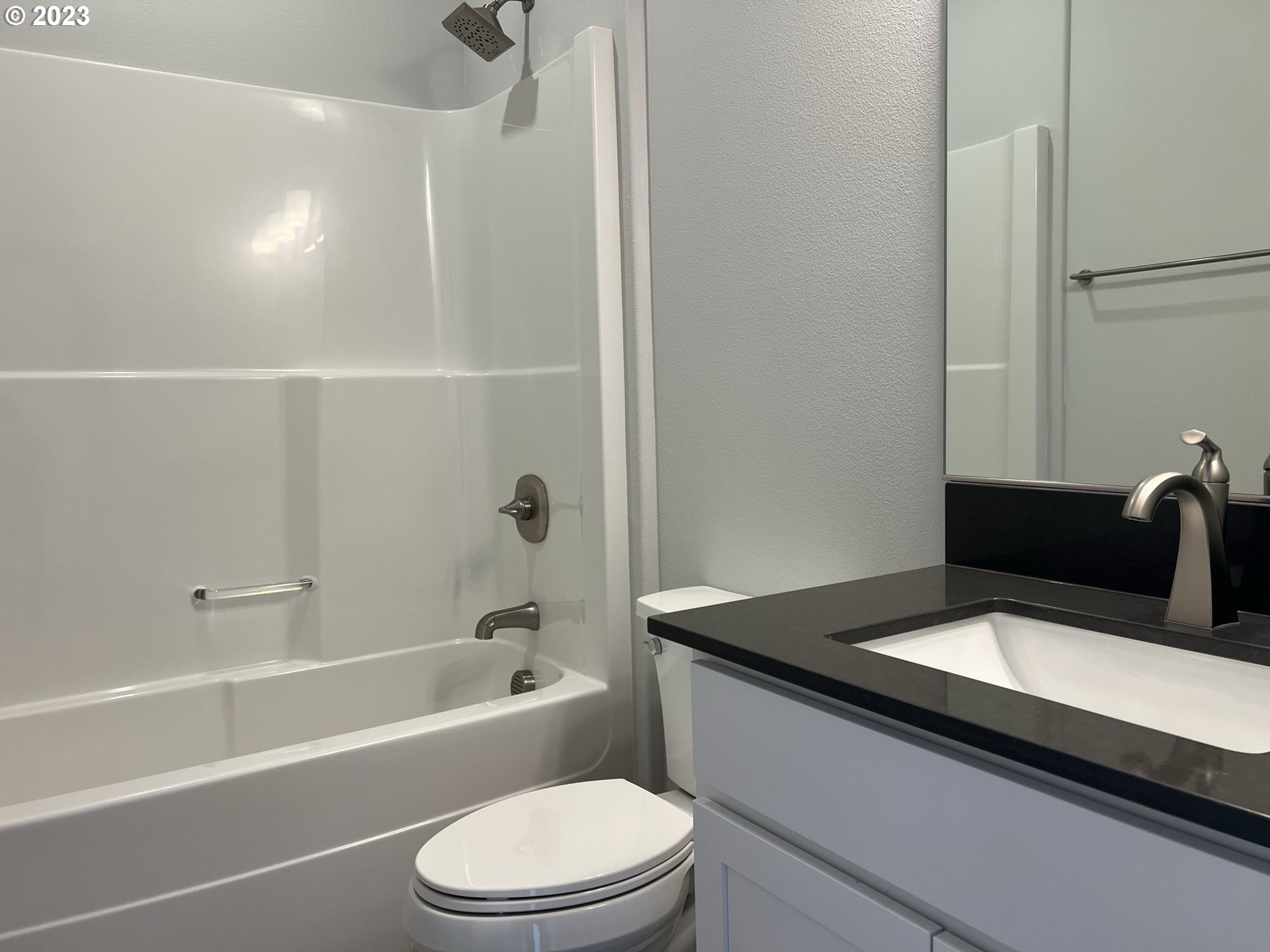 1435 Fish Tail Road Maupin, OR 97037 - Photo 20 of 31 a bathroom with a granite countertop sink toilet a mirror and shower