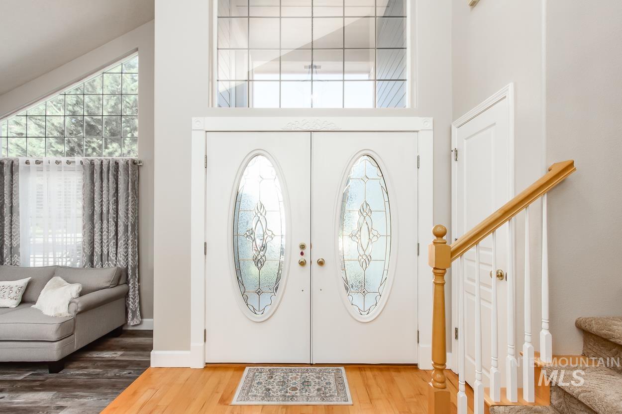 5674 North Heathrow Way Boise, ID 83713 - Photo 2 of 41 Double entry doors with decorative oval glass inserts, complemented by a transom window above