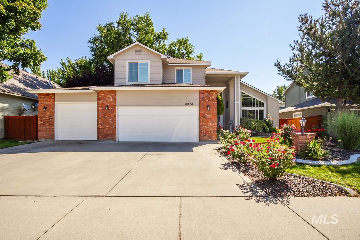5674 North Heathrow Way Boise, ID 83713 - Photo 39 of 41 Contemporary two-story residence featuring a two-car garage, brick accents, and a concrete driveway