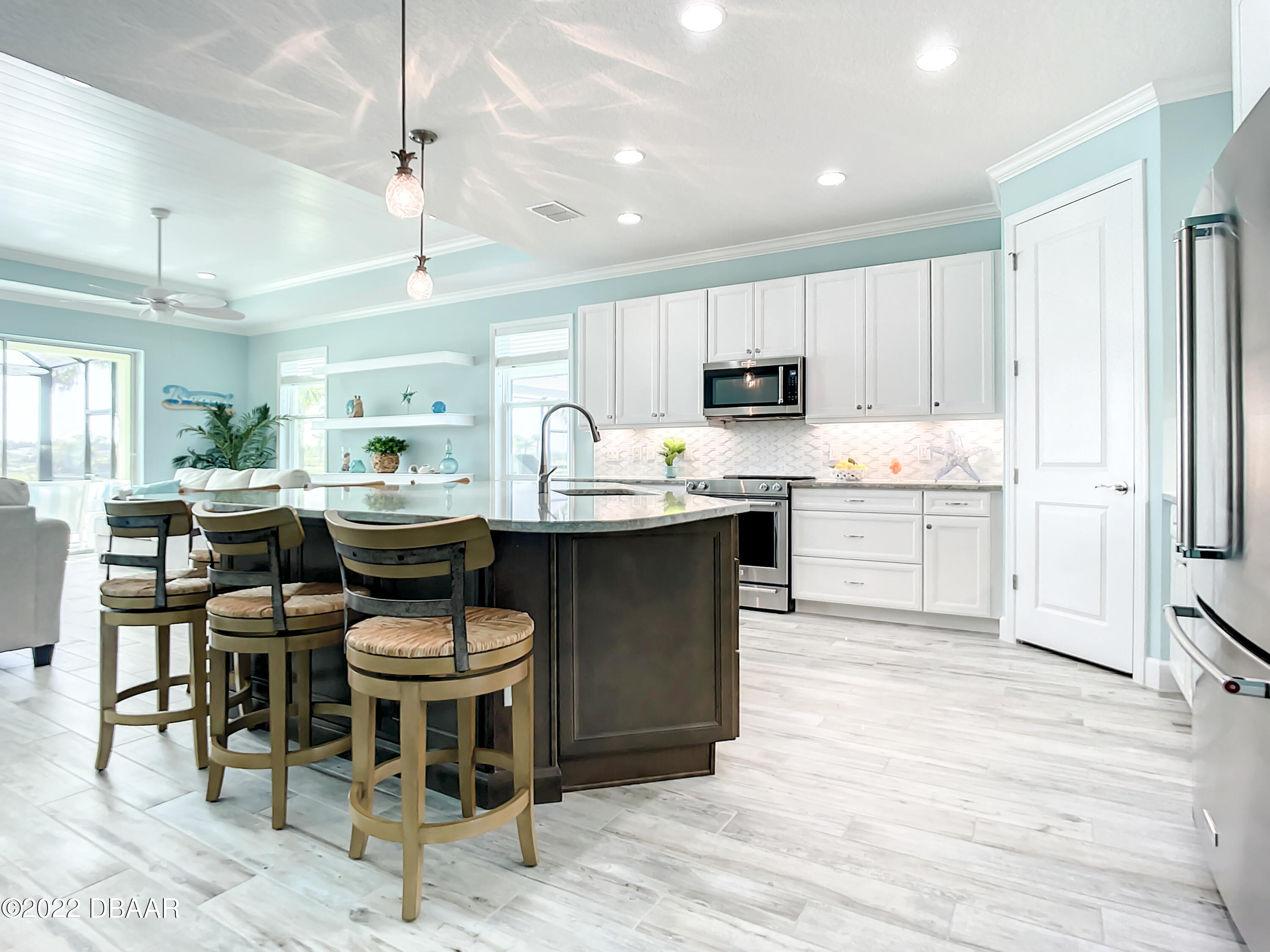 124 Red Lighthouse Point Daytona Beach, FL 32124 - Photo 5 of 54 a kitchen with stainless steel appliances kitchen island granite countertop a table chairs sink and cabinets
