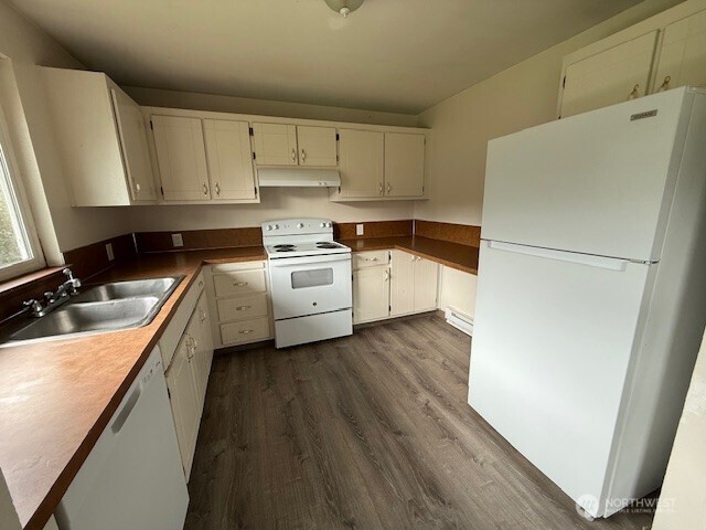 1913 Coolidge Road Aberdeen, WA 98520 - Photo 15 of 18 a kitchen with white cabinets and white appliances