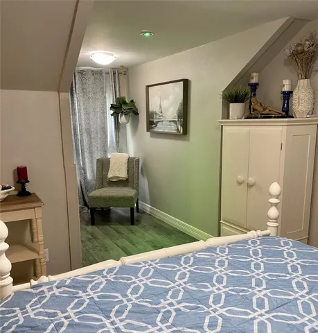 a bedroom with a bed and a couch