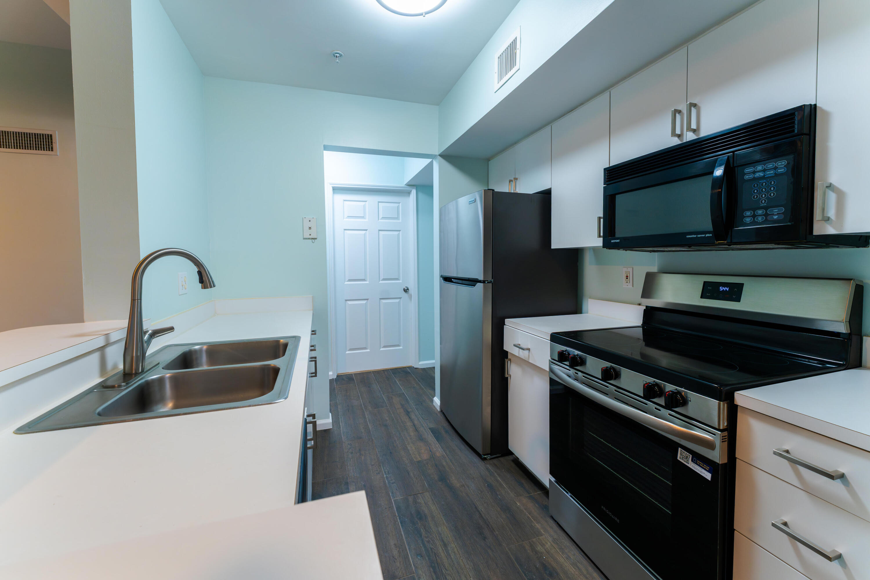 236 Village Boulevard, Unit 1304 Tequesta, FL 33469 - Photo 12 of 30 a kitchen with stainless steel appliances a stove a sink and a microwave