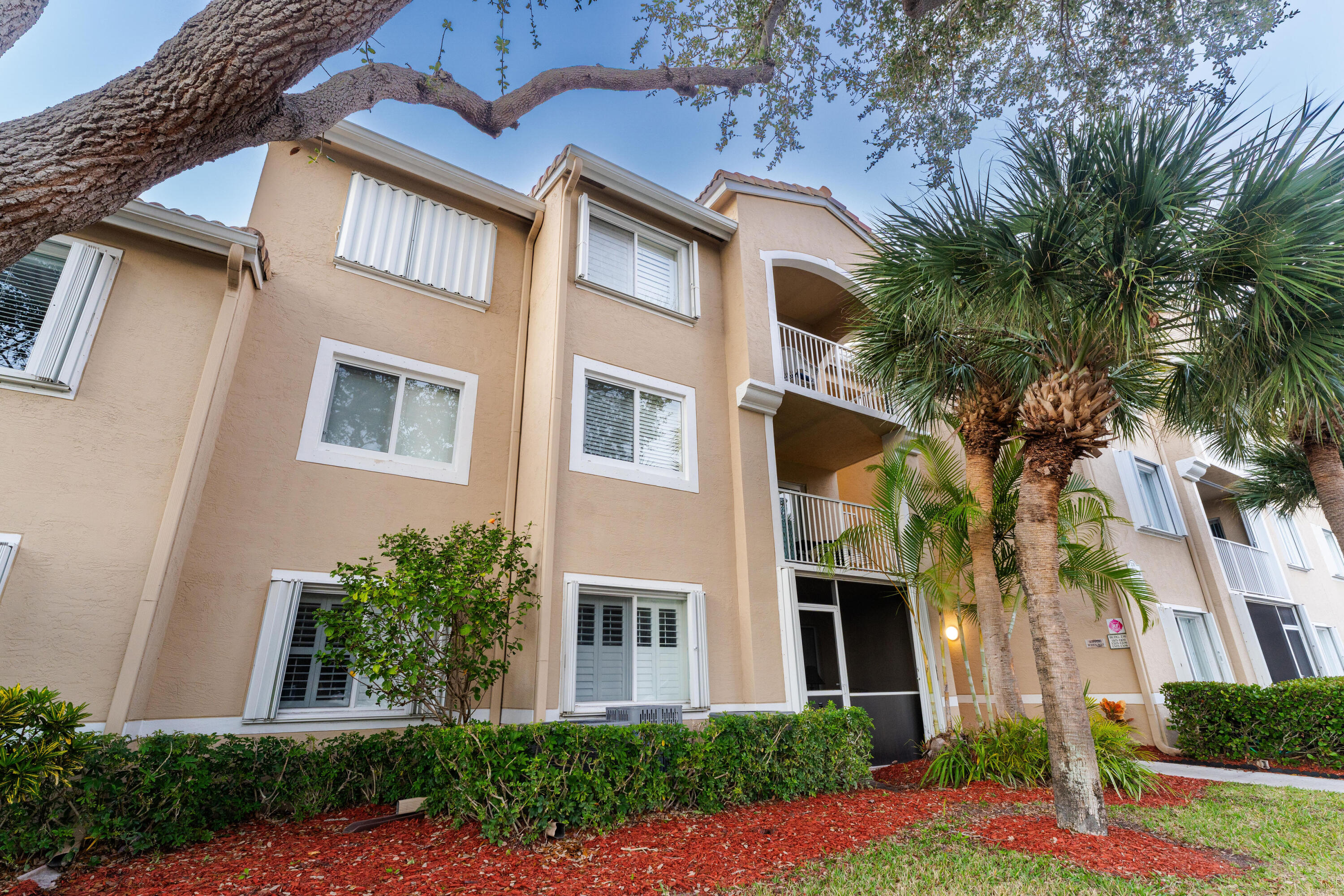 236 Village Boulevard, Unit 1304 Tequesta, FL 33469 - Photo 18 of 30 a front view of a house with a yard
