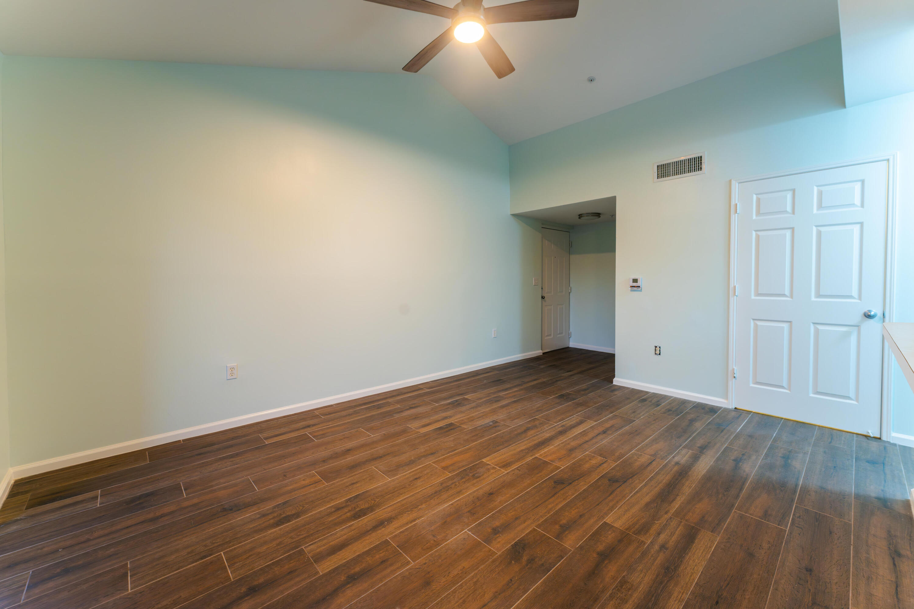 236 Village Boulevard, Unit 1304 Tequesta, FL 33469 - Photo 2 of 30 an empty room with wooden floor and windows