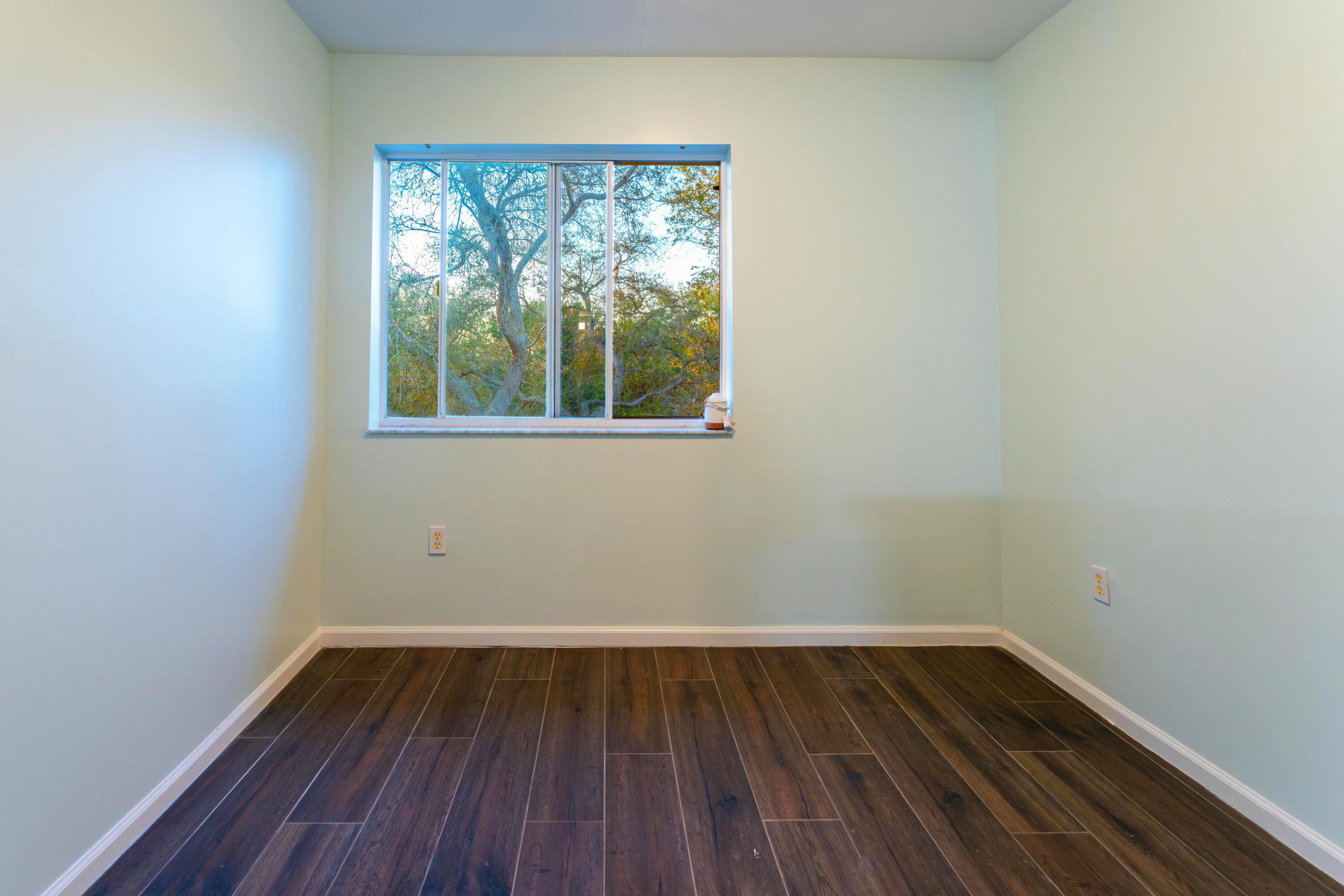 236 Village Boulevard, Unit 1304 Tequesta, FL 33469 - Photo 24 of 30 a view of a room with wooden floor and window
