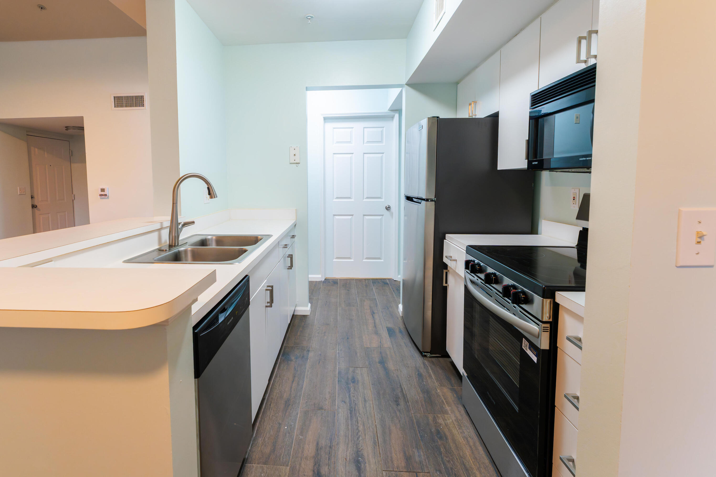 236 Village Boulevard, Unit 1304 Tequesta, FL 33469 - Photo 25 of 30 a kitchen with a sink stove and refrigerator