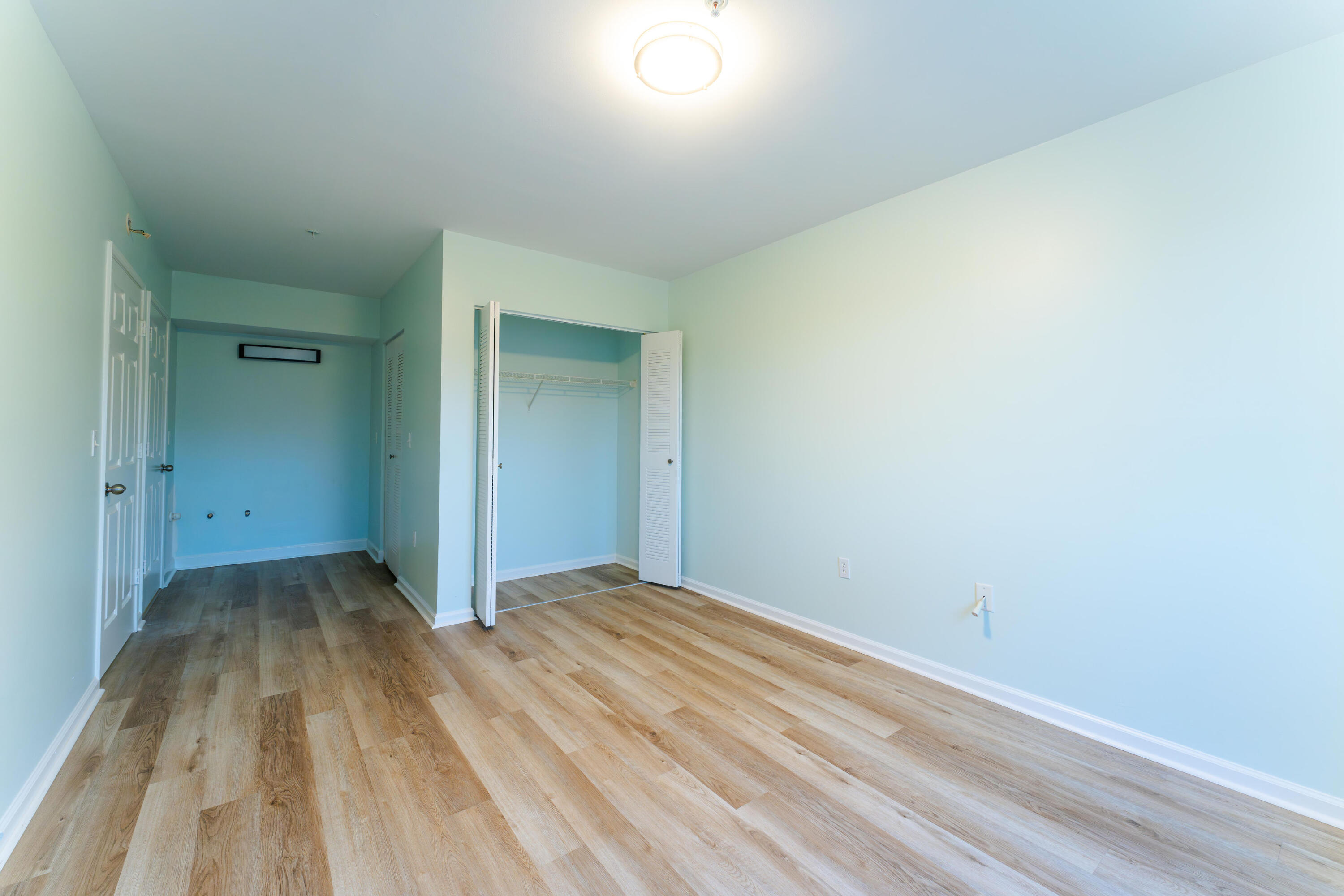 236 Village Boulevard, Unit 1304 Tequesta, FL 33469 - Photo 8 of 30 a view of an empty room and wooden floor