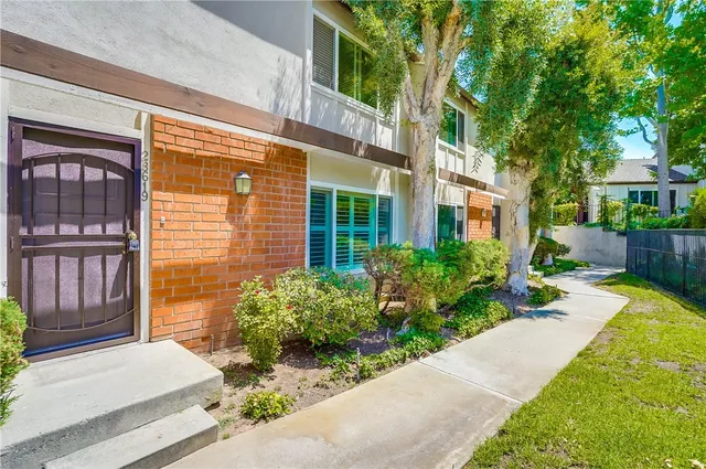 a view of a house with a garden and pathway