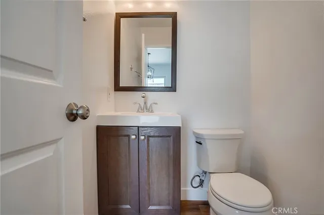 a bathroom with a toilet a sink a vanity and mirror