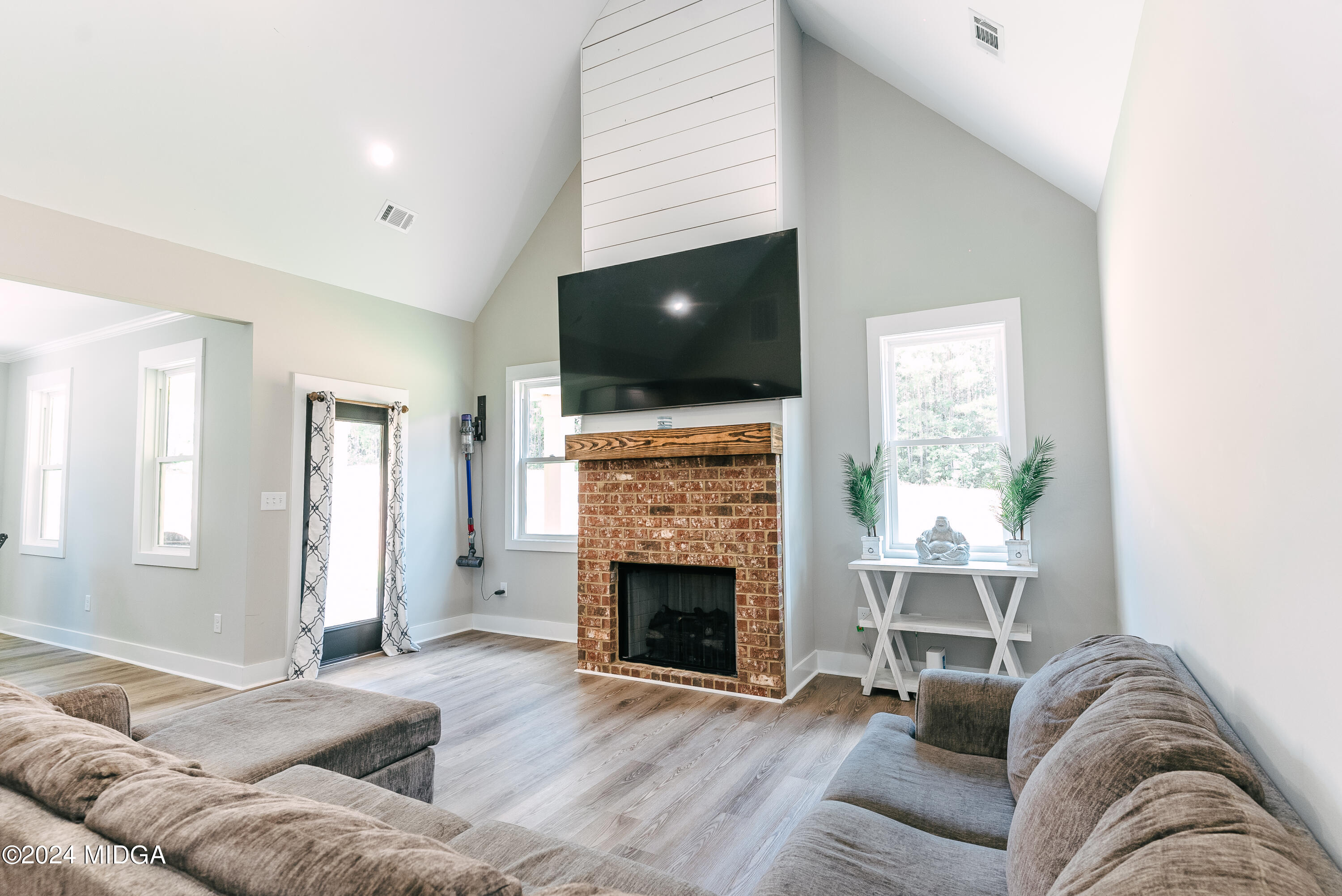 1190 Josey Road Forsyth, GA 31029 - Photo 11 of 25 a living room with furniture and a flat screen tv