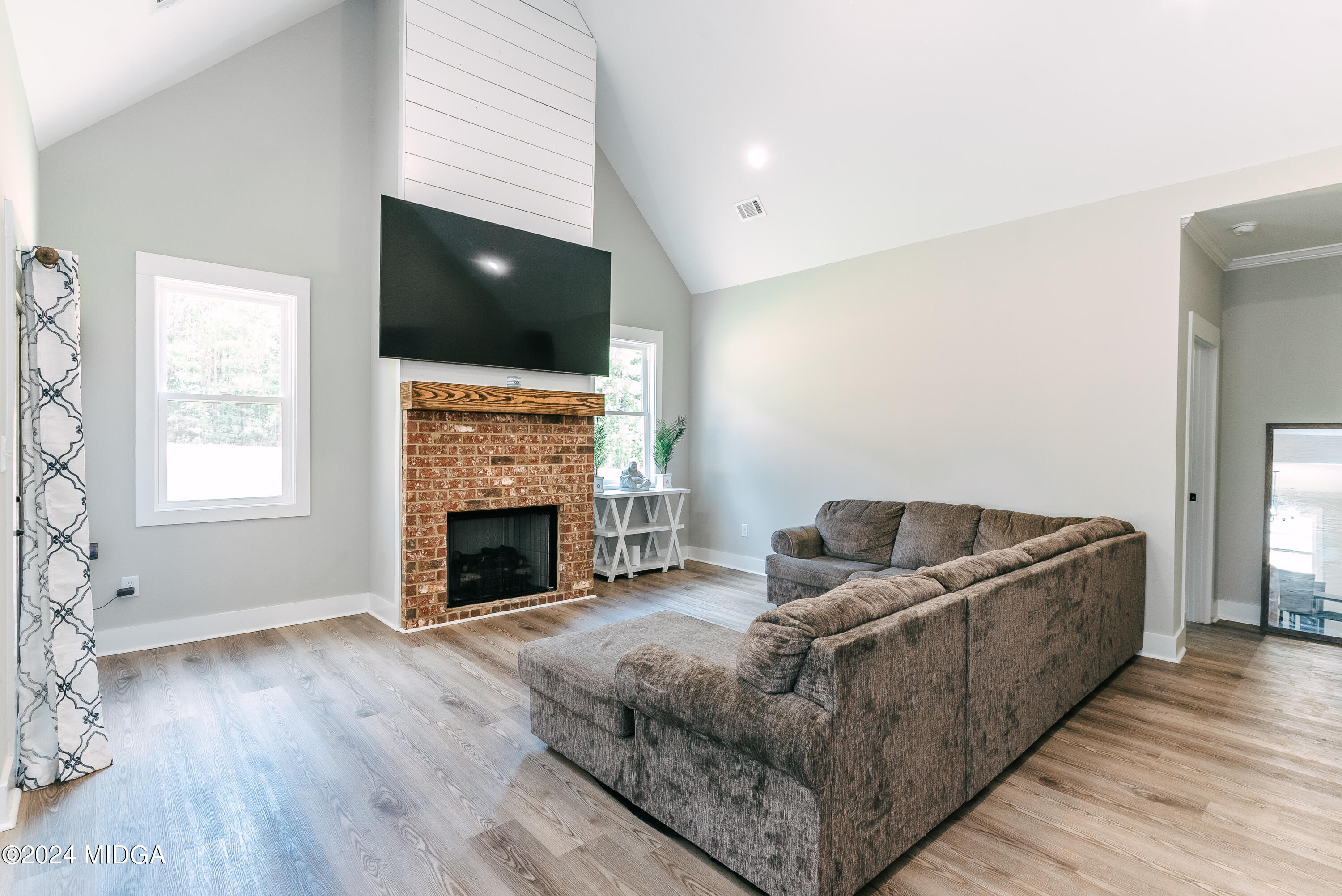 1190 Josey Road Forsyth, GA 31029 - Photo 13 of 25 a living room with furniture and a fireplace