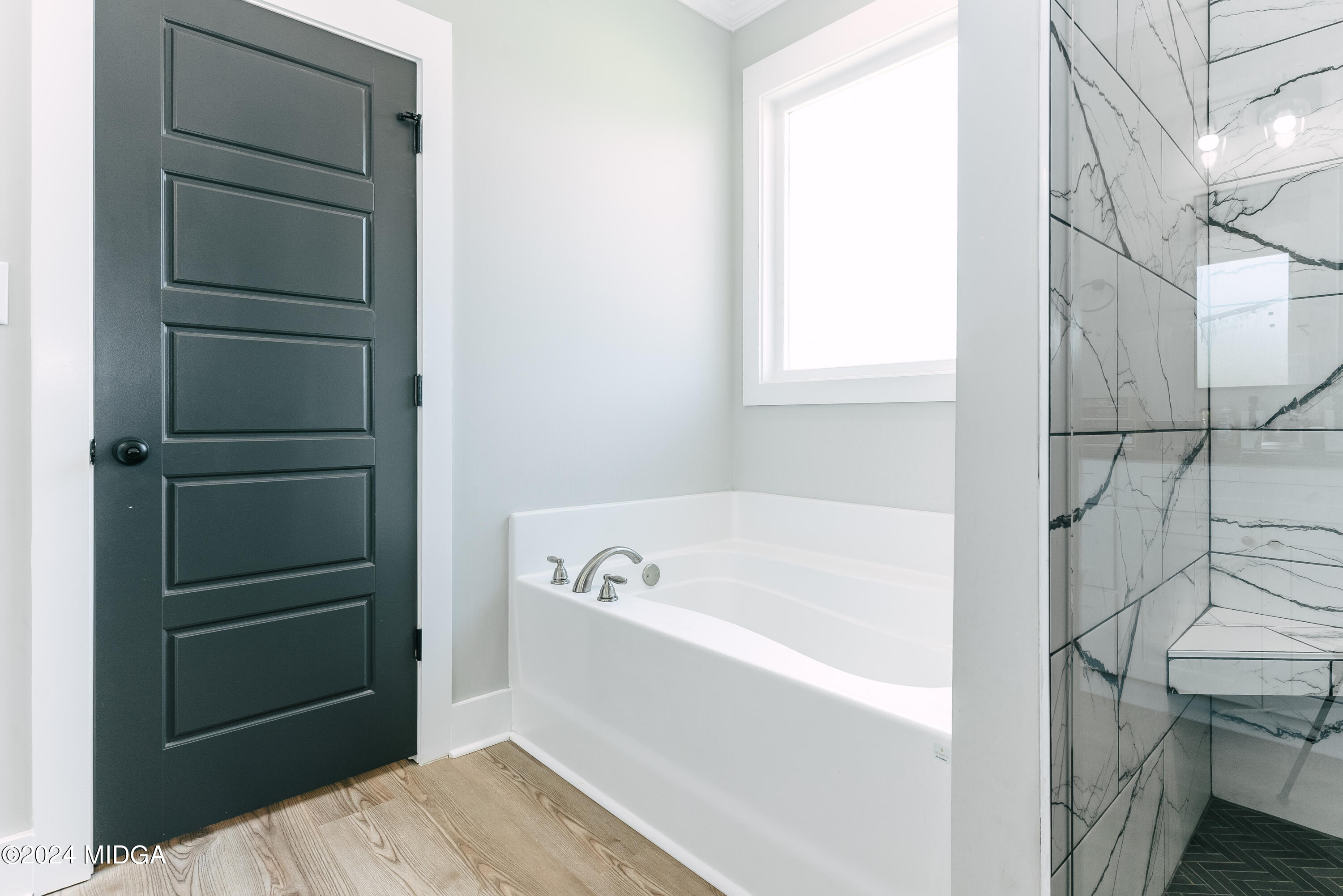 1190 Josey Road Forsyth, GA 31029 - Photo 16 of 25 a bathroom with a bathtub and a window