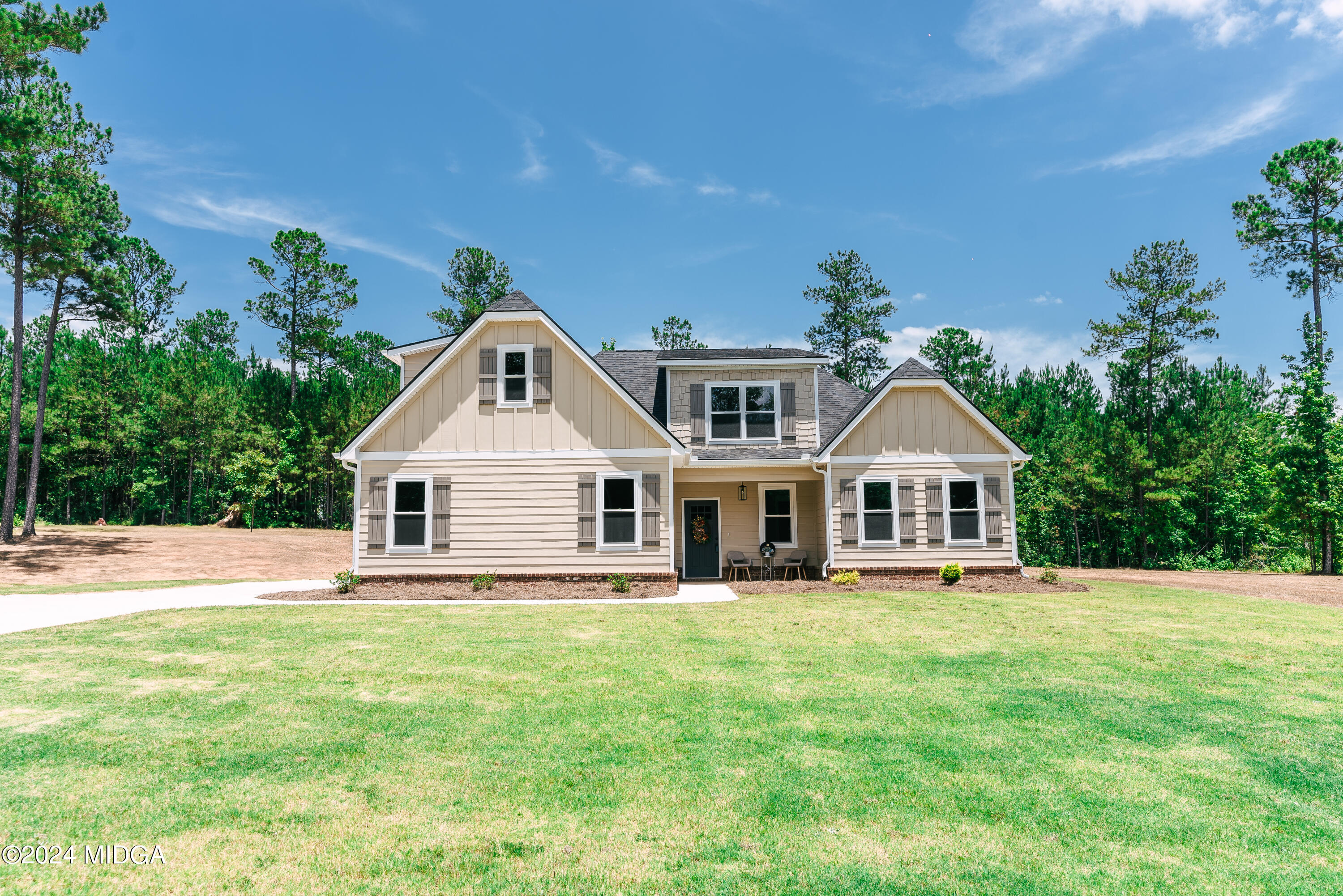 1190 Josey Road Forsyth, GA 31029 - Photo 2 of 25 a front view of a house with a yard and trees
