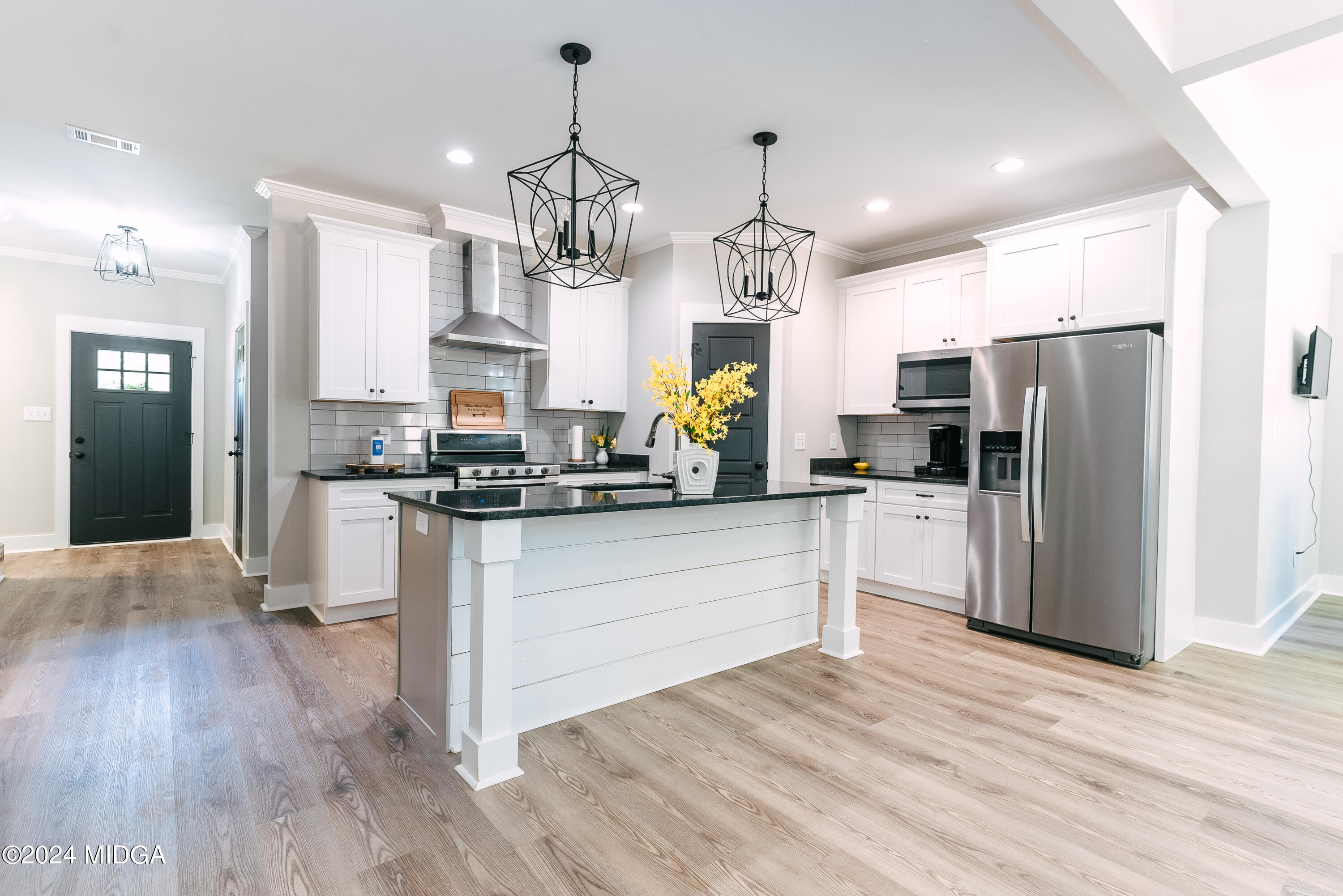 1190 Josey Road Forsyth, GA 31029 - Photo 5 of 25 a kitchen with stainless steel appliances kitchen island granite countertop a refrigerator a oven a stove and white cabinets with wooden floor