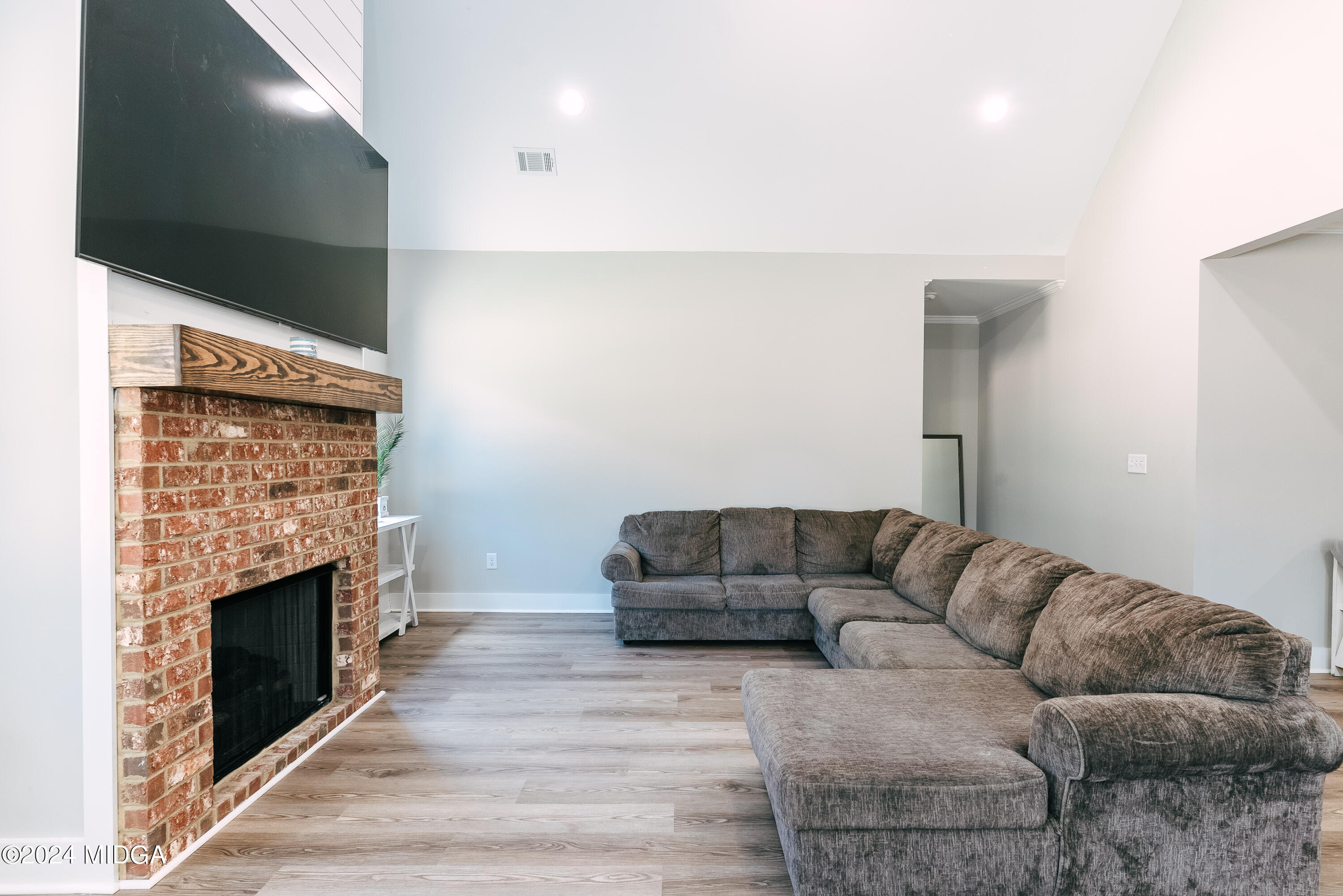 1190 Josey Road Forsyth, GA 31029 - Photo 10 of 25 a living room with furniture a flat screen tv and a fireplace
